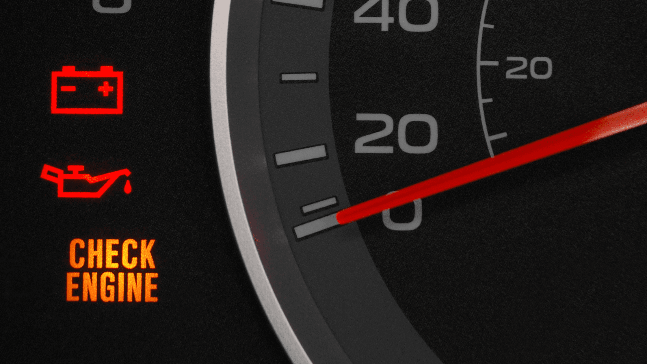 Close up image of an illuminated check engine light on a vehicle's dashboard
